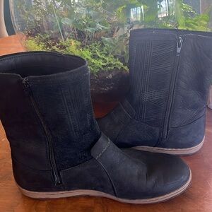 Black Merrell water resistant boots with size zip closure